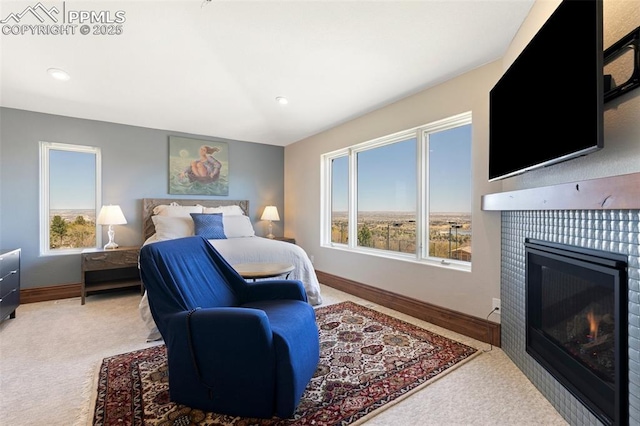 3870 S Club Dr, Colorado Springs, CO 80906 - carpeted bedroom featuring a tiled fireplace, baseboards, and recessed lighting