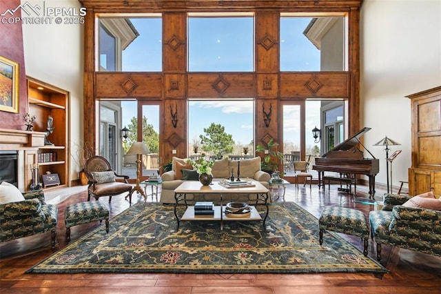 3870 S Club Dr, Colorado Springs, CO 80906 - living room featuring a wealth of natural light, hardwood / wood-style floors, and a high ceiling