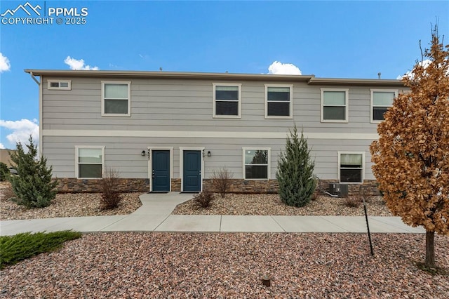 4691 Pleasant Port Vw, Colorado Springs, CO 80911 - view of front facade featuring stone siding and central AC unit