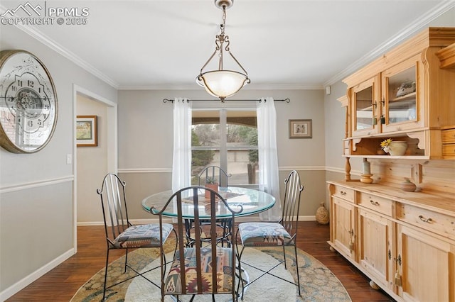 dining room with baseboards, ornamental molding, and dark wood-type flooring