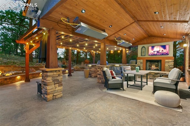 view of patio with an outdoor living space with a fireplace