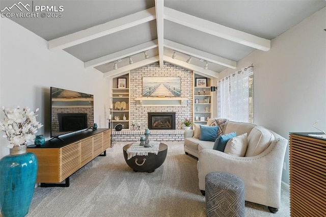 living room with built in shelves, a fireplace, carpet flooring, and lofted ceiling with beams