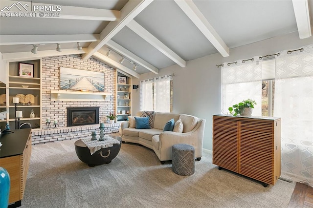 carpeted living area featuring vaulted ceiling with beams, built in shelves, and a brick fireplace