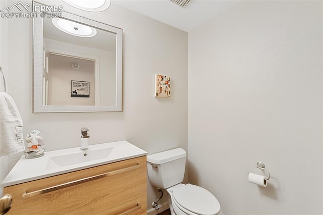 bathroom featuring toilet and vanity