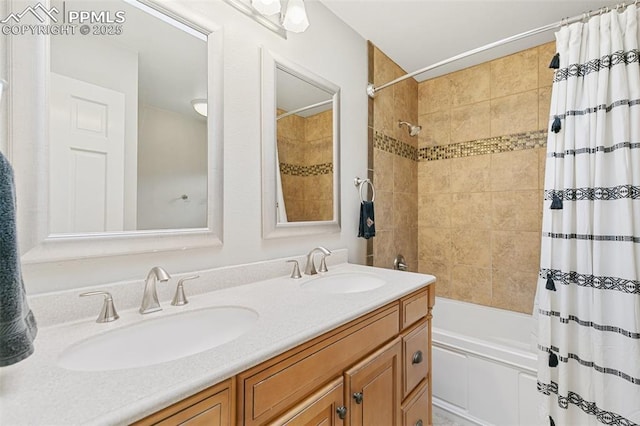 full bath with double vanity, shower / tub combo, and a sink