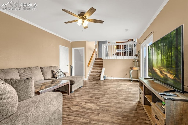 7775 Woody Creek Dr, Colorado Springs, CO 80911 - living area with crown molding, baseboards, stairs, wood finished floors, and a ceiling fan