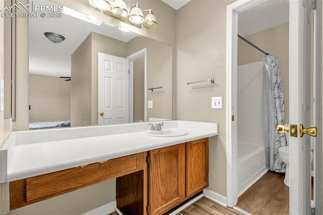 7775 Woody Creek Dr, Colorado Springs, CO 80911 - full bathroom with toilet, vanity, shower / bath combo, wood finished floors, and baseboards