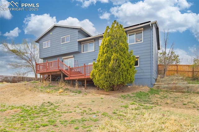 7775 Woody Creek Dr, Colorado Springs, CO 80911 - rear view of house with a wooden deck and fence