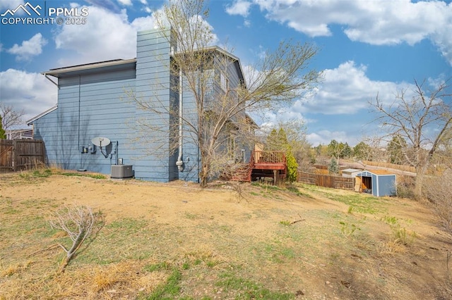 7775 Woody Creek Dr, Colorado Springs, CO 80911 - view of home's exterior with a chimney and fence