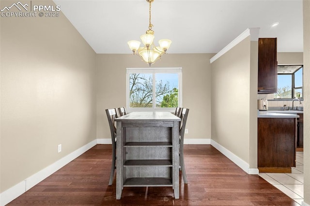 7775 Woody Creek Dr, Colorado Springs, CO 80911 - dining area with a wealth of natural light, a notable chandelier, wood finished floors, and baseboards