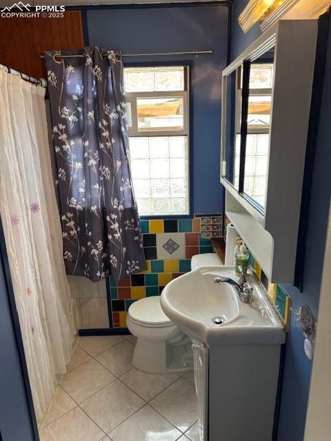 bathroom featuring tile patterned floors, vanity, and toilet