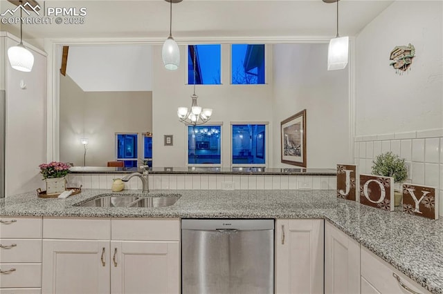 2372 Wood Ave, Colorado Springs, CO 80907 - kitchen featuring white cabinetry, a sink, light stone countertops, and dishwasher