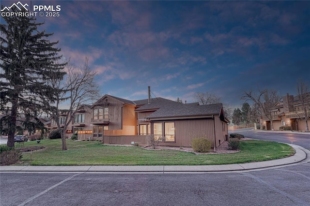 2372 Wood Ave, Colorado Springs, CO 80907 - view of front of house featuring roof with shingles and a yard
