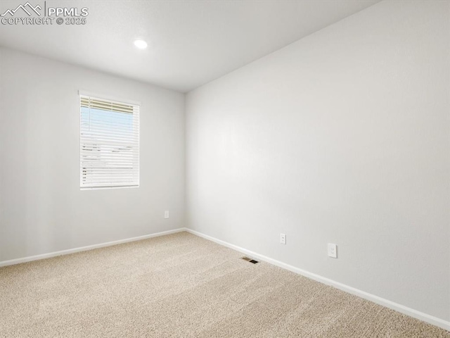 spare room with visible vents, baseboards, and carpet flooring