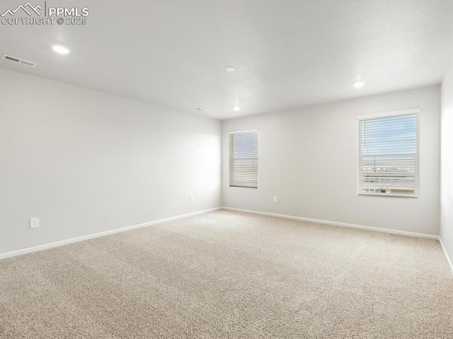 empty room featuring recessed lighting, visible vents, baseboards, and light carpet