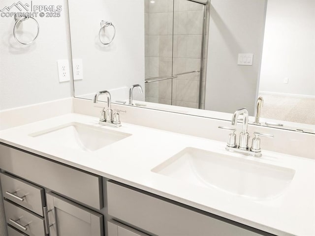 full bath featuring a sink, double vanity, and tiled shower