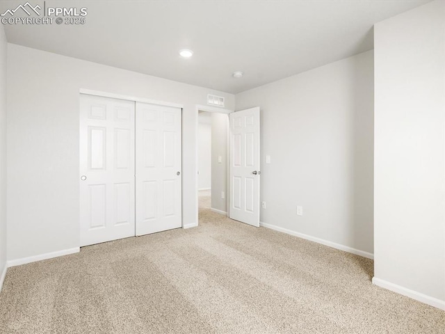 unfurnished bedroom featuring a closet, carpet, baseboards, visible vents, and recessed lighting
