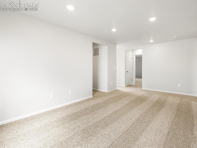 unfurnished room with light colored carpet, baseboards, visible vents, and recessed lighting