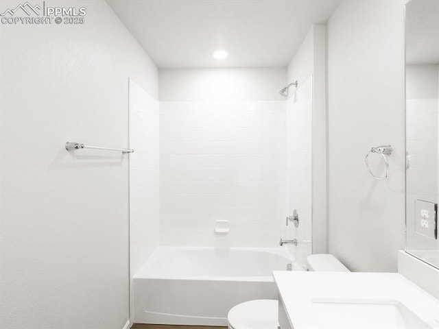bathroom featuring toilet, vanity, and bathtub / shower combination