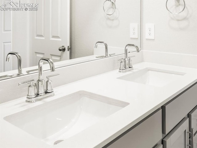 full bathroom featuring a sink and double vanity