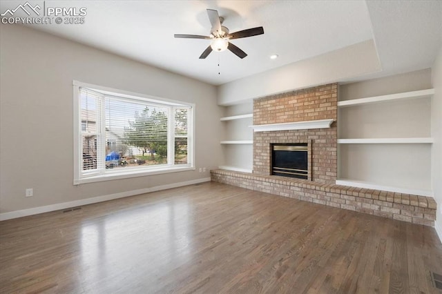 15110 Copperfield Dr, Colorado Springs, CO 80921 - unfurnished living room featuring baseboards, built in features, a ceiling fan, and wood finished floors