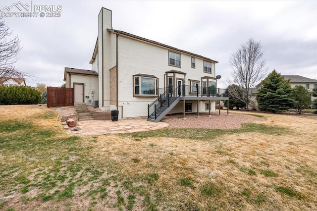 15110 Copperfield Dr, Colorado Springs, CO 80921 - back of property featuring a chimney, a patio area, stairs, a wooden deck, and a yard