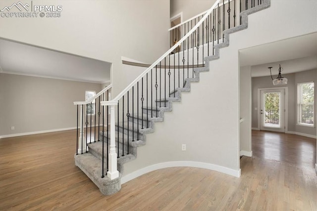 15110 Copperfield Dr, Colorado Springs, CO 80921 - stairs with a towering ceiling, baseboards, ornamental molding, and wood finished floors