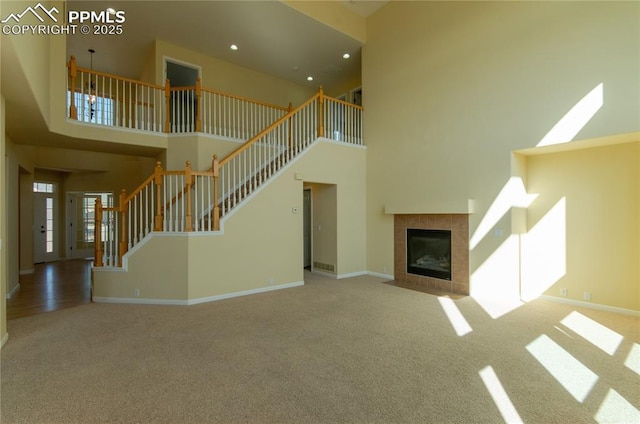 9443 St George Rd, Peyton, CO 80831 - unfurnished living room with a high ceiling, baseboards, and carpet floors