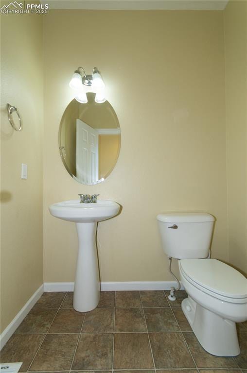 9443 St George Rd, Peyton, CO 80831 - half bath with toilet, tile patterned floors, and baseboards