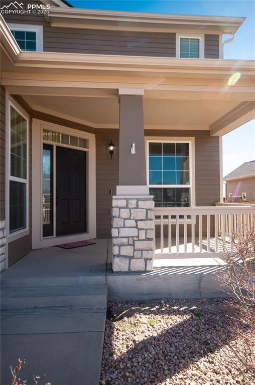 9443 St George Rd, Peyton, CO 80831 - view of exterior entry featuring covered porch