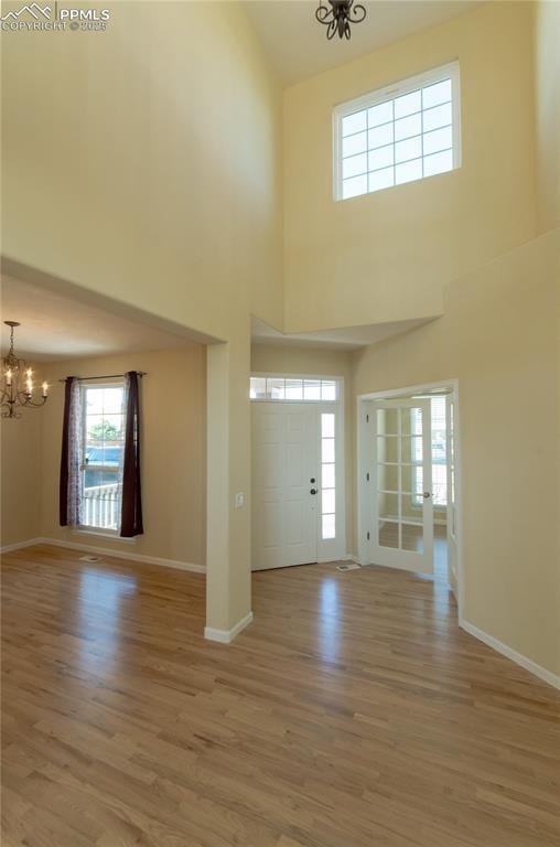 9443 St George Rd, Peyton, CO 80831 - entrance foyer with baseboards, light wood-type flooring, and a chandelier