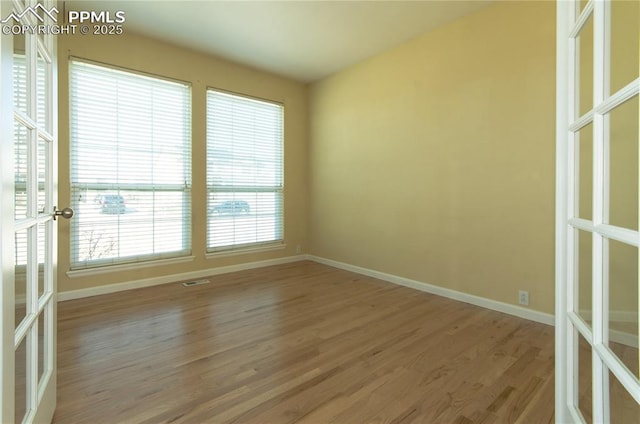 9443 St George Rd, Peyton, CO 80831 - empty room featuring french doors, baseboards, light wood-type flooring, and visible vents