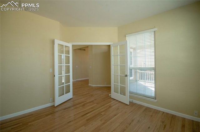 9443 St George Rd, Peyton, CO 80831 - spare room featuring a wealth of natural light, french doors, baseboards, and wood finished floors