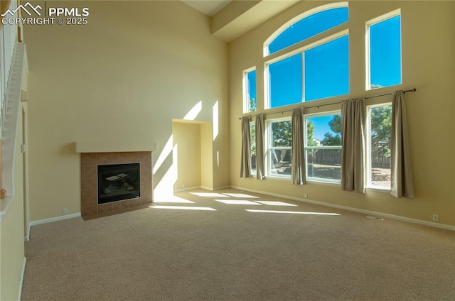 9443 St George Rd, Peyton, CO 80831 - unfurnished living room featuring carpet floors, baseboards, and a towering ceiling