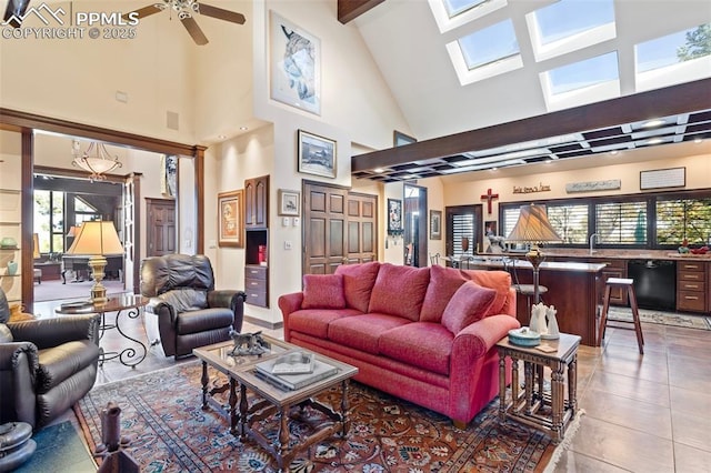 714 Southern Cross Pl, Colorado Springs, CO 80906 - living area featuring tile patterned floors, vaulted ceiling with skylight, visible vents, and a ceiling fan