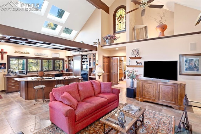 714 Southern Cross Pl, Colorado Springs, CO 80906 - living room with ceiling fan, a toaster, lofted ceiling with skylight, and a baseboard heating unit