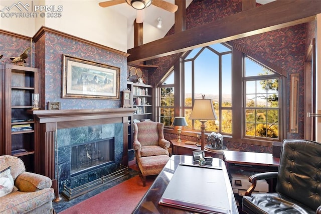 714 Southern Cross Pl, Colorado Springs, CO 80906 - office featuring a ceiling fan, a high end fireplace, beamed ceiling, wallpapered walls, and high vaulted ceiling
