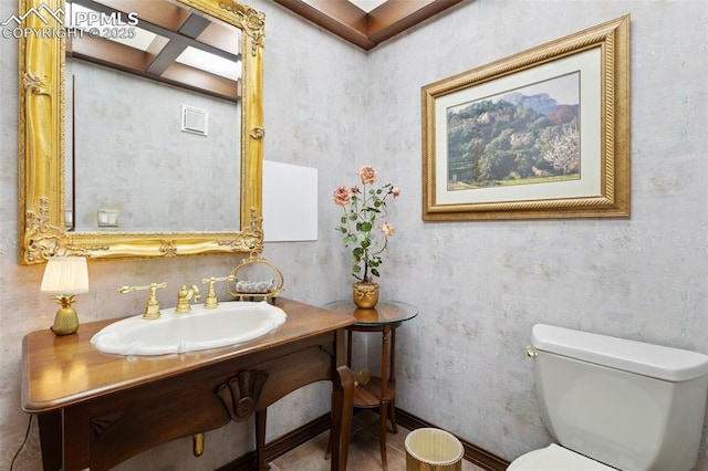 714 Southern Cross Pl, Colorado Springs, CO 80906 - bathroom with a sink, toilet, and wallpapered walls