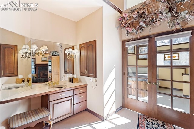 714 Southern Cross Pl, Colorado Springs, CO 80906 - bathroom featuring a chandelier, french doors, vanity, and baseboards