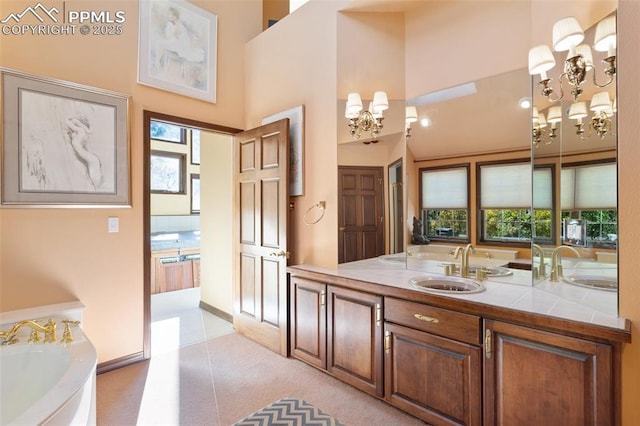 714 Southern Cross Pl, Colorado Springs, CO 80906 - bathroom featuring a sink, a high ceiling, a chandelier, and a garden tub