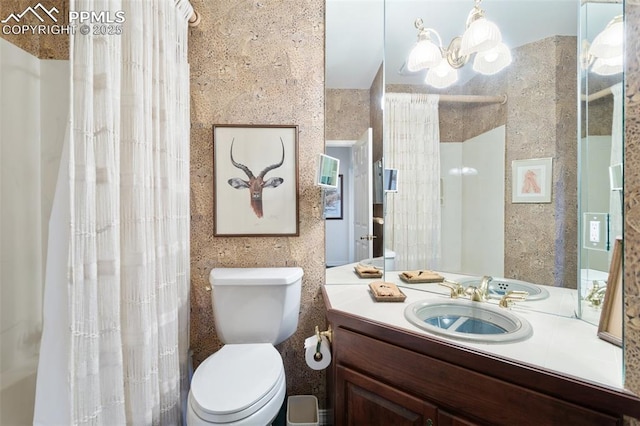 714 Southern Cross Pl, Colorado Springs, CO 80906 - bathroom with toilet, vanity, and a notable chandelier