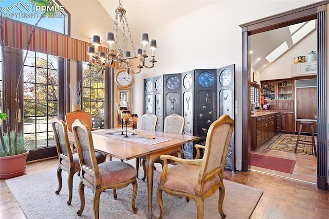 714 Southern Cross Pl, Colorado Springs, CO 80906 - dining space featuring a healthy amount of sunlight, high vaulted ceiling, and a notable chandelier