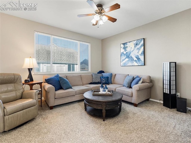 carpeted living room with ceiling fan and baseboards