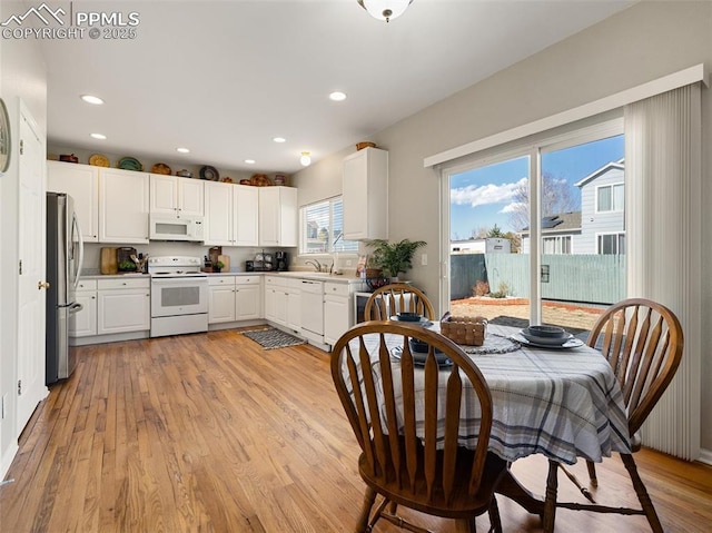 dining space with light wood-style floors and recessed lighting