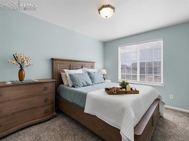 bedroom featuring carpet and baseboards