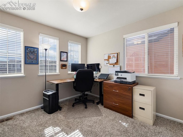 home office featuring light carpet, baseboards, and visible vents
