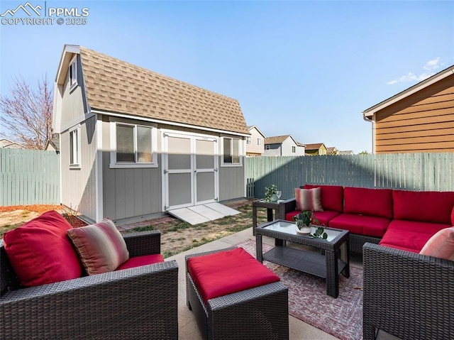 view of patio with an outdoor living space, a fenced backyard, a storage shed, and an outbuilding