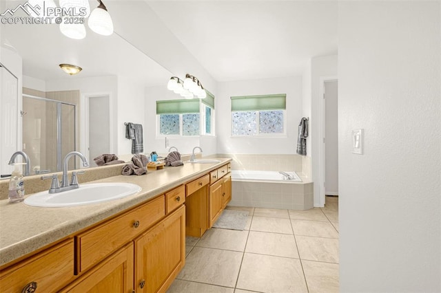 bathroom with a sink, tile patterned flooring, a stall shower, and a garden tub