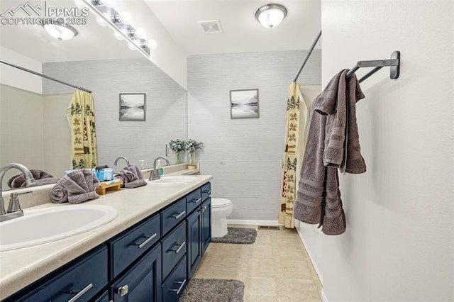bathroom featuring visible vents, a shower with curtain, and a sink