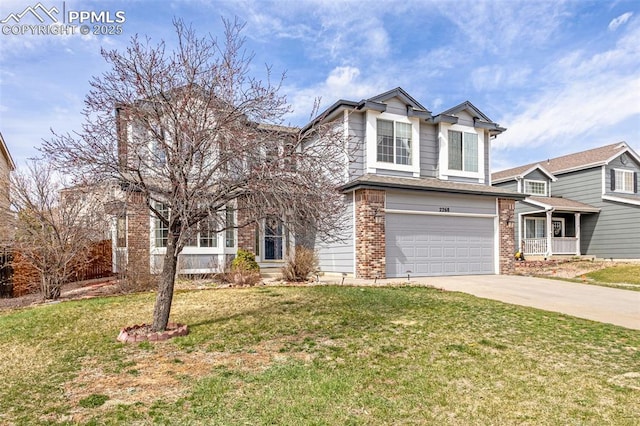 traditional home featuring brick siding, a front yard, an attached garage, and concrete driveway